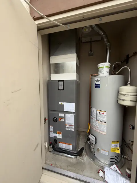 A furnace and tank water heater with visible piping and vent connections.