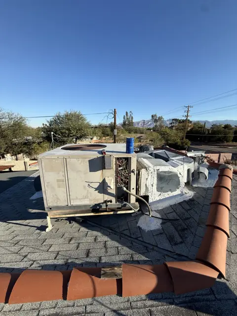 A packaged rooftop unit with an access panel removed during service.