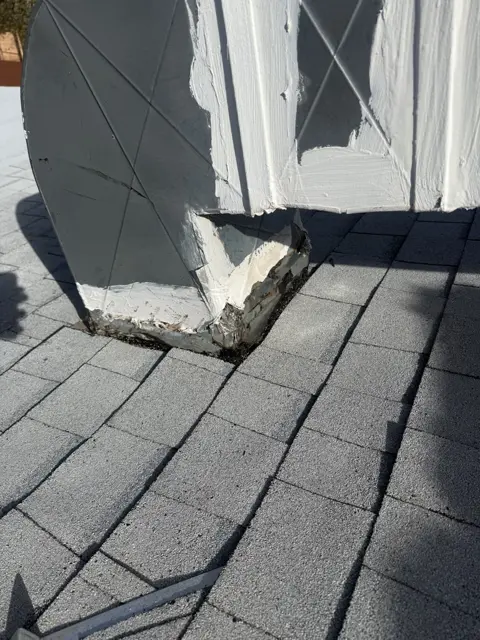 A close-up of the exterior duct connection at the roof surface.
