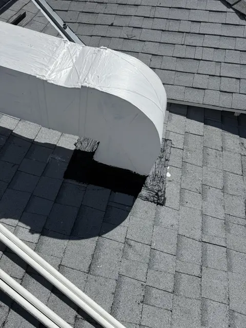 A curved exterior duct section connecting rooftop HVAC equipment.