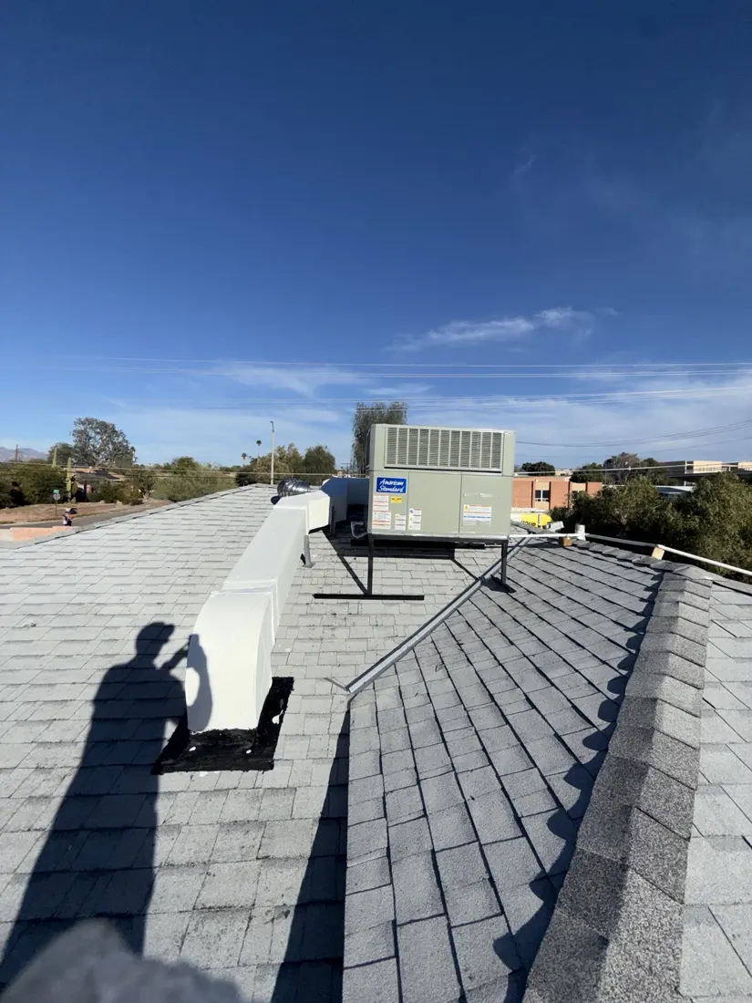 Packaged rooftop HVAC unit with closed service panels and connected ductwork