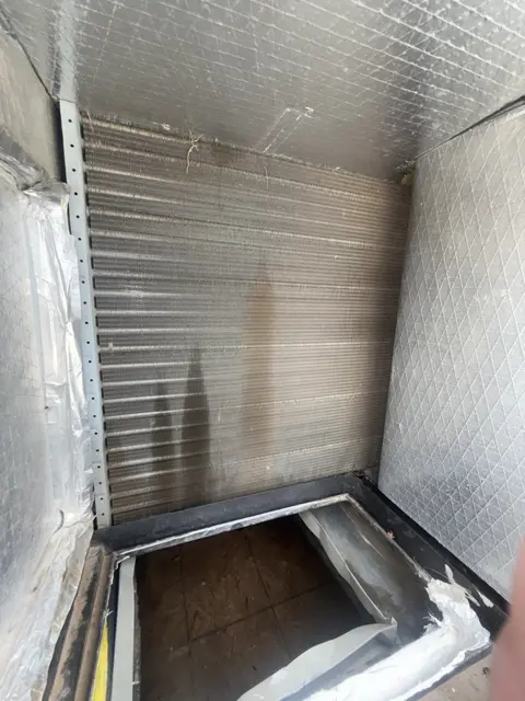 An open view of the metal-lined interior of an HVAC air passage.