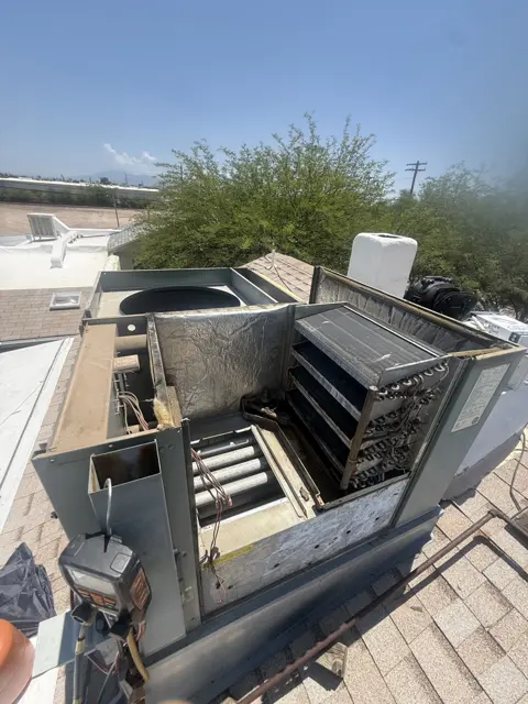 An open rooftop HVAC system showing its internal components during service.