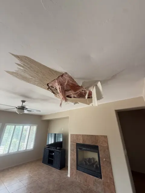 Ceiling damage and an exposed opening documented during a service visit. This is a condition photo, not a finished repair.