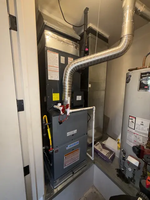 A furnace and tank water heater sharing a utility closet.